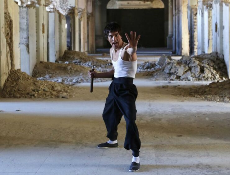 Abbas Alizada, who calls himself the Afghan Bruce Lee, poses for the media in Kabul.