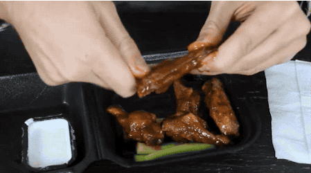Pulling the bones out of a chicken wing makes it easier to eat. Just twist the bone and pull. (40 of 50)