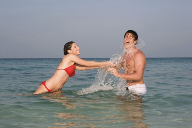 Asia, Thailand, Young Couple in ocean, splashing water