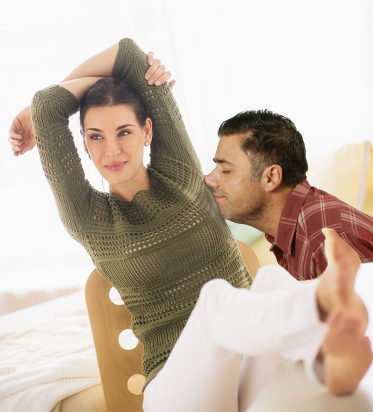 Woman with feet up and hands behind head