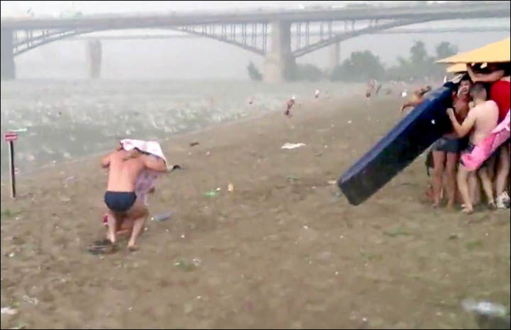 inside man under towel and people under umbrella