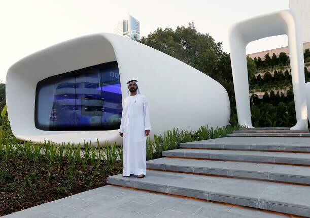 Sheikh Mohammed bin Rashid Al Maktoum stands in front of the world's first functional 3D printed offices during the official opening in Dubai