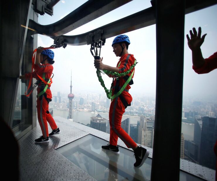 instead-brave-walkers-are-strapped-to-the-side-of-the-building-via-harness-employees-who-work-in-the-tower-were-the-first-to-try-it-out